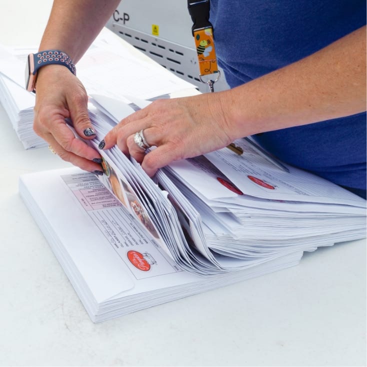 Photo of a volunteer flipping through Mrs. Pumpkins Fundraising Order Forms